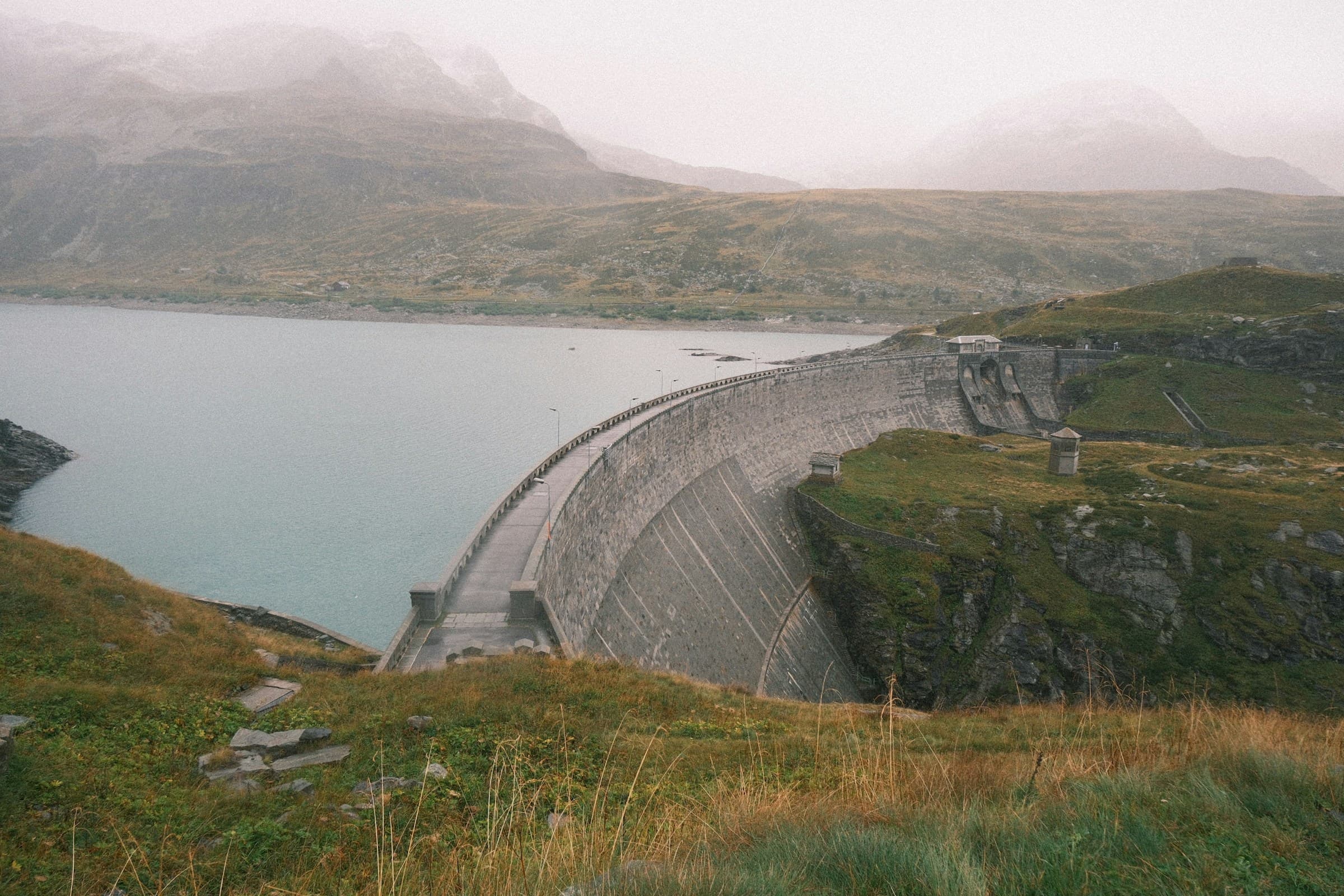 Arched dark room interior with a single circular skylight casting light from above